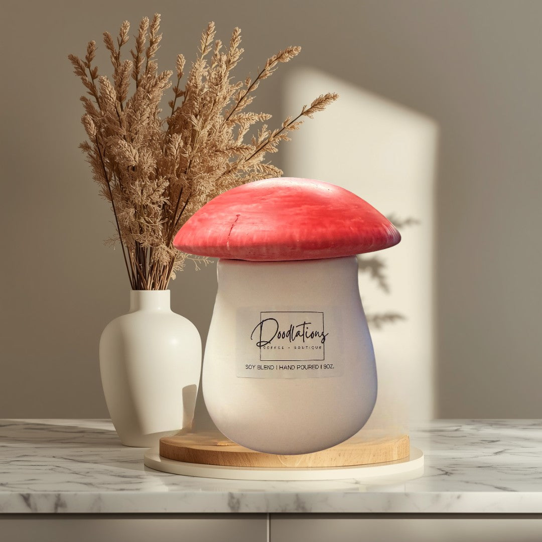 mushroom-shaped concrete candle with a red cap and white base, soy blend wax, salted honey scent.