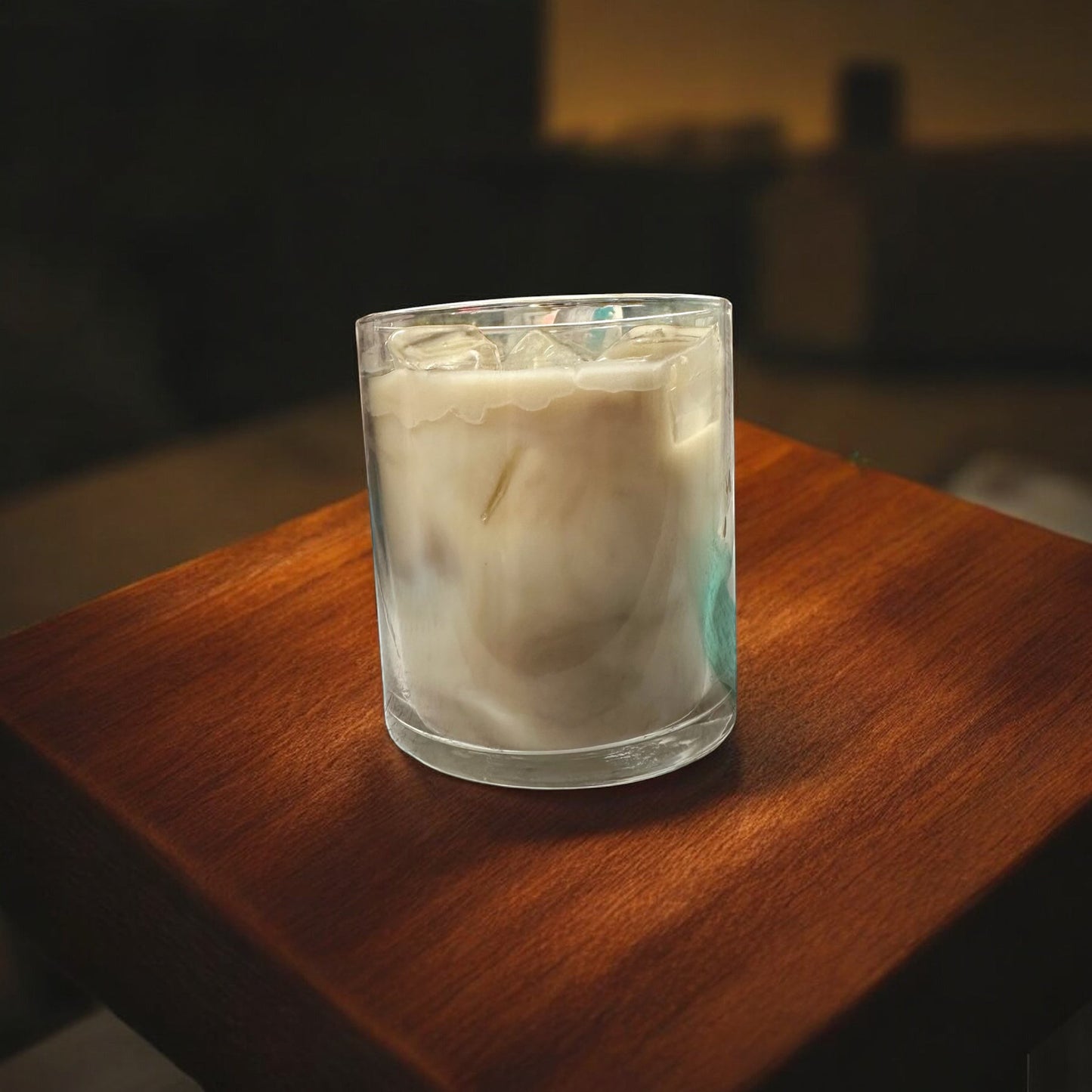 Black Powder Iced Coffee candle in a glass jar with a creamy white wax and faux ice cubes on top.