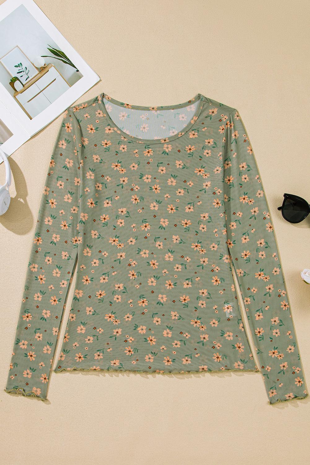 Floral patterned long-sleeve shirt on a beige surface