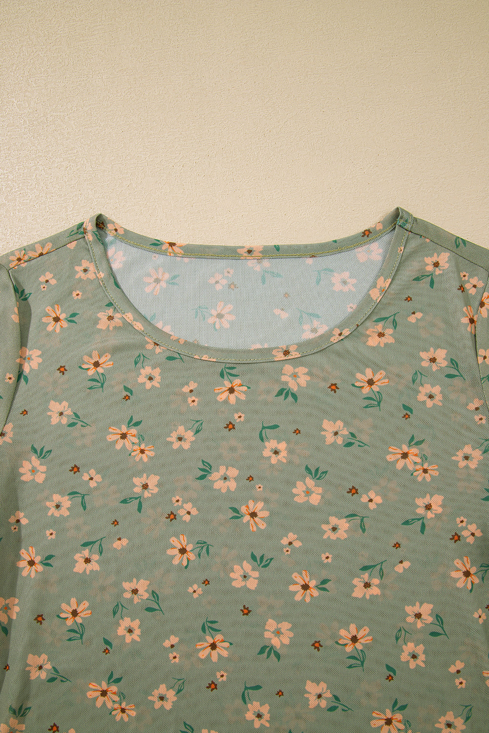 Floral patterned top on a plain background