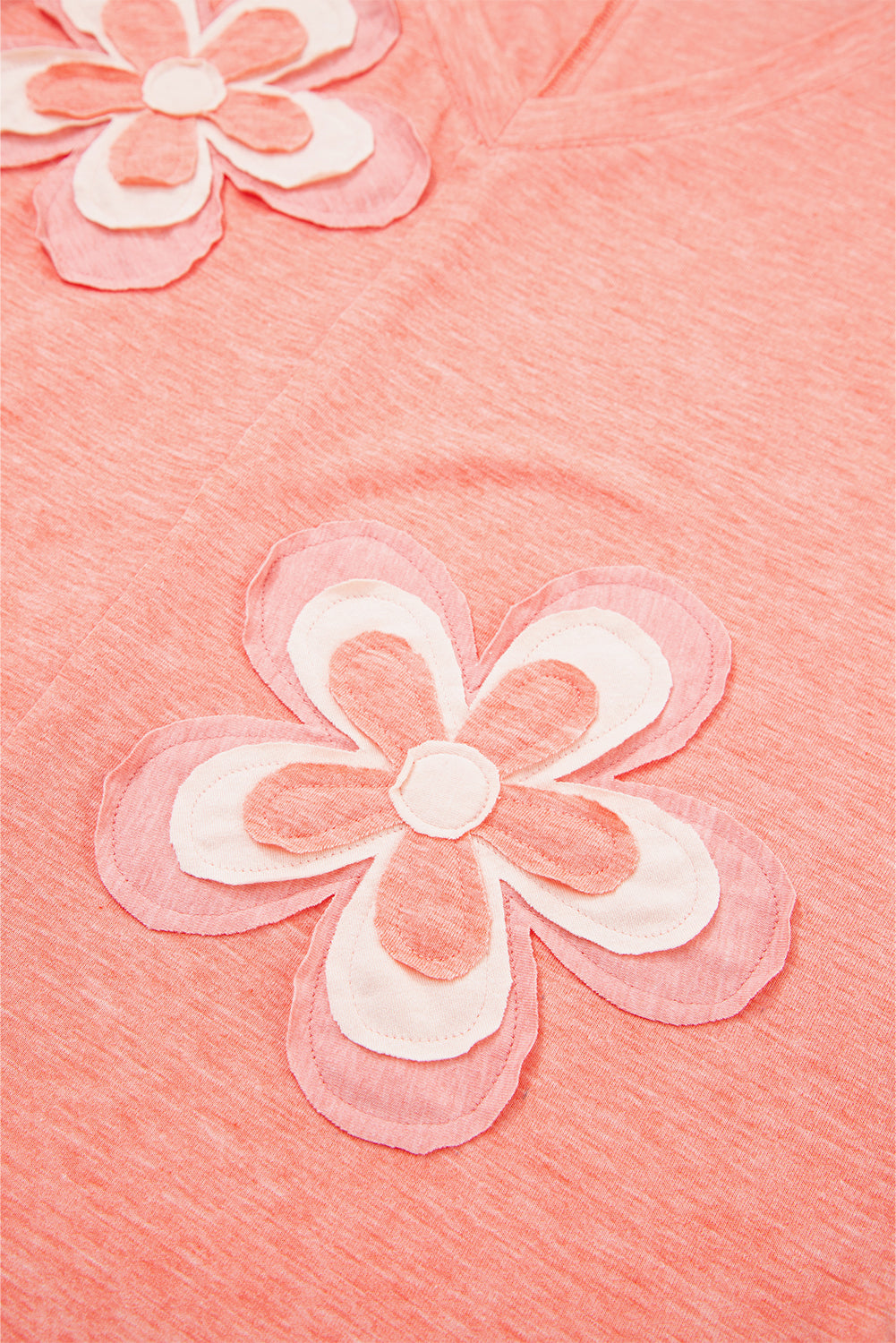 Close-up of pink fabric with white flower patterns