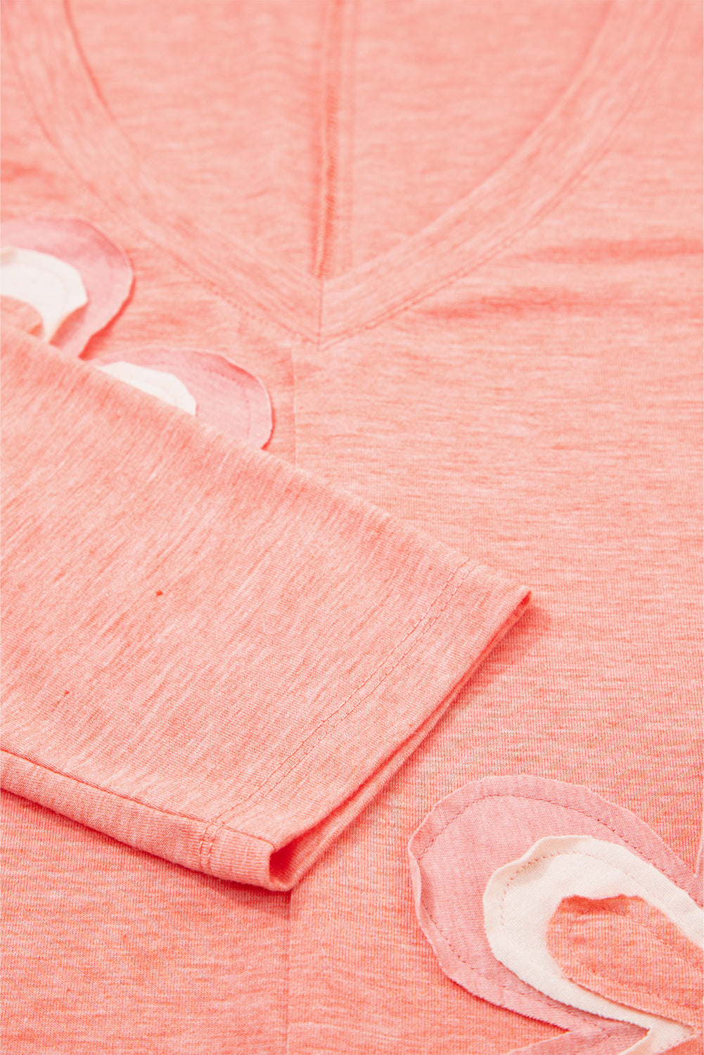 Close-up of pink fabric with white floral patterns