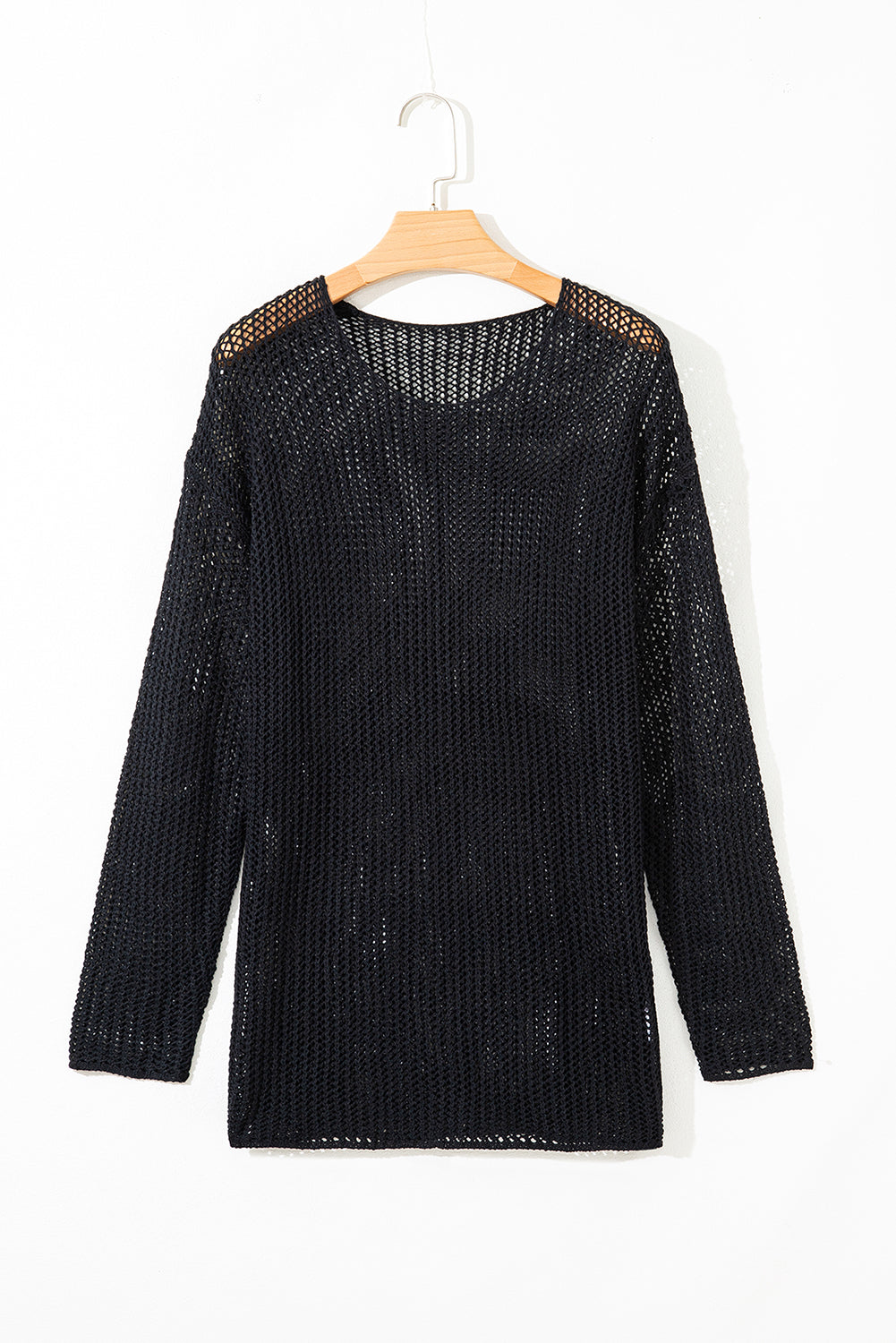 Black knit sweater on a wooden hanger against a white background