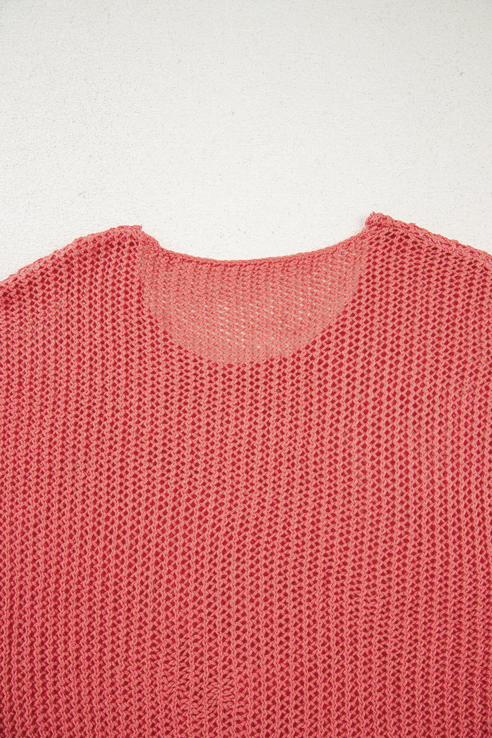 Close-up of a pink knitted sweater on a white background
