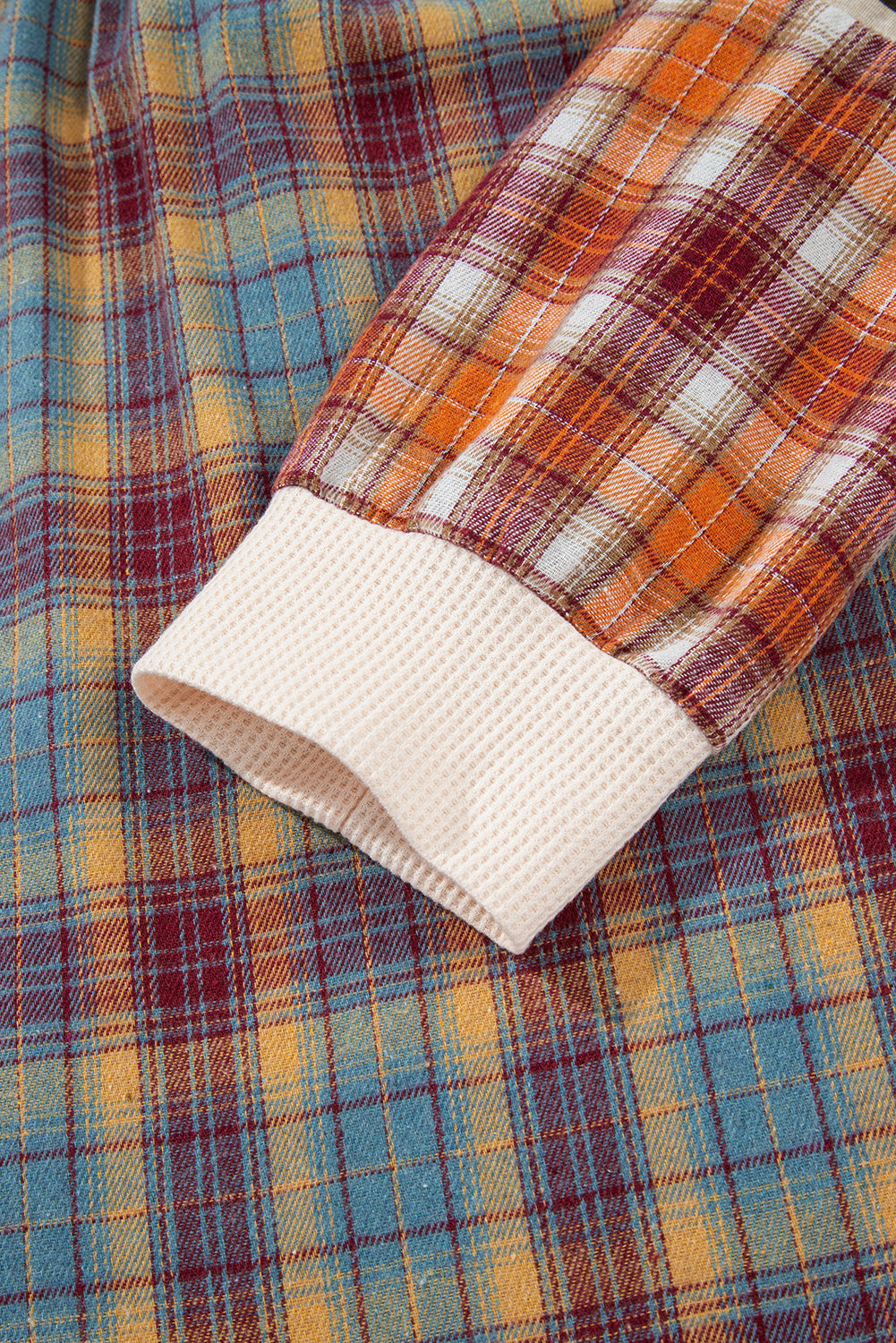 Close-up of plaid fabric with a focus on the edge and texture.