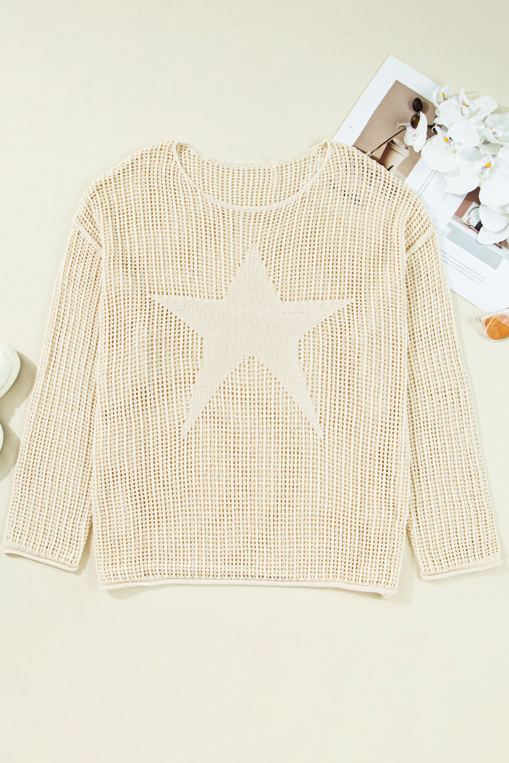 Beige sweater with a star design on a light background