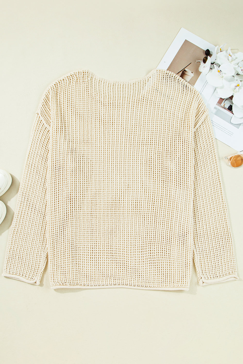 Beige knitted sweater on a light beige background