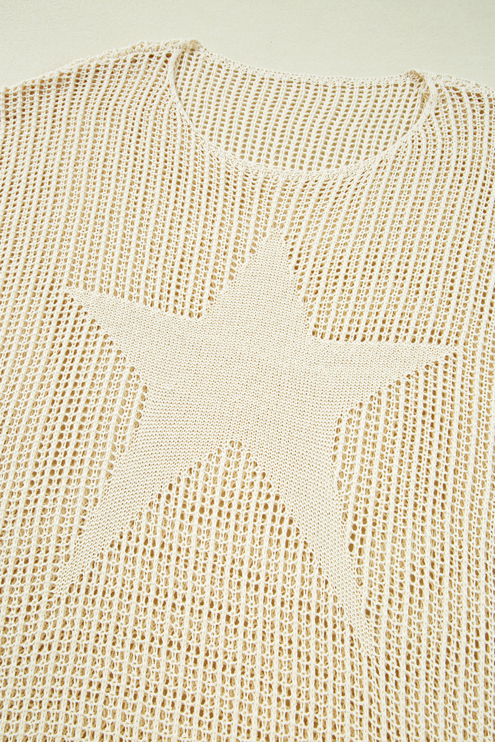 Close-up of a textured beige fabric with star patterns