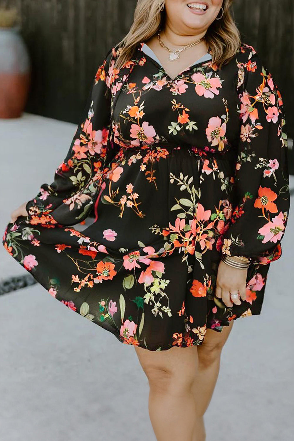 Woman wearing a black floral dress with a blurred background