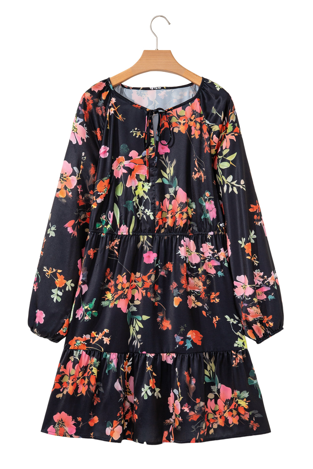 Floral dress on a hanger against a white background