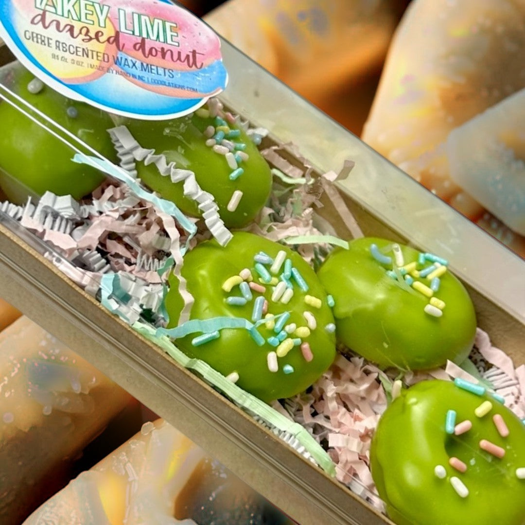 Doodlations Coffee Bar & Boutique Key Lime Donut wax melts in bright green with colorful sprinkles, shaped like donuts.