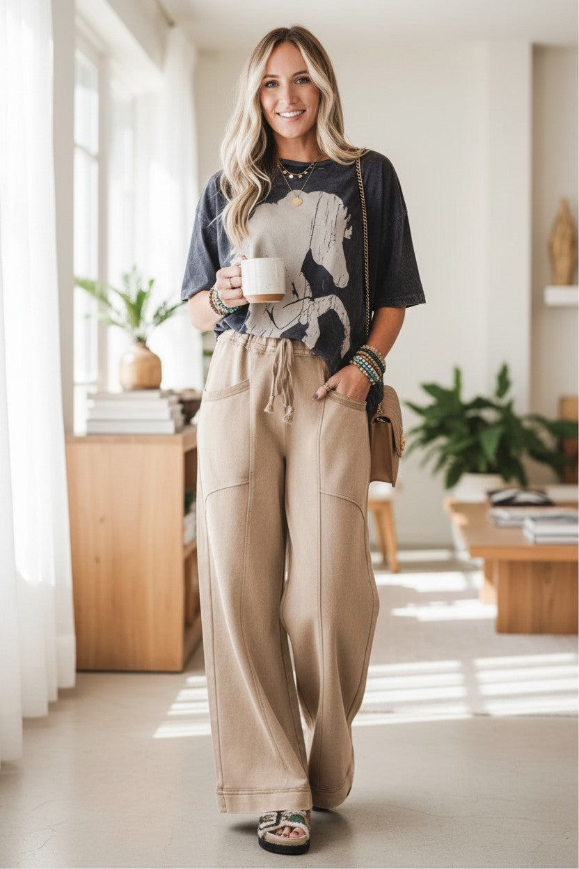 Doodlations Coffee Bar & Boutique mineral wash tan wide-leg drawstring pants with pockets and contrast stitching.
