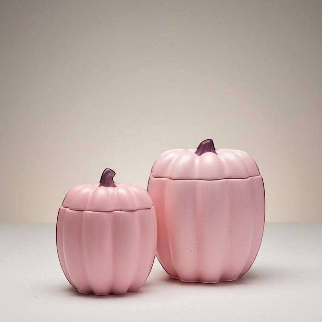 Doodlations Coffee Bar & Boutique pink concrete pumpkin candles in two sizes with purple stems. Soy blend wax.