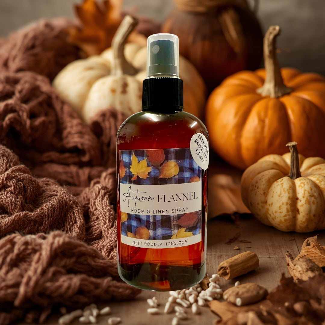 Doodlations Coffee Bar & Boutique Autumn Flannel room and linen spray in amber bottle with fall leaf label.