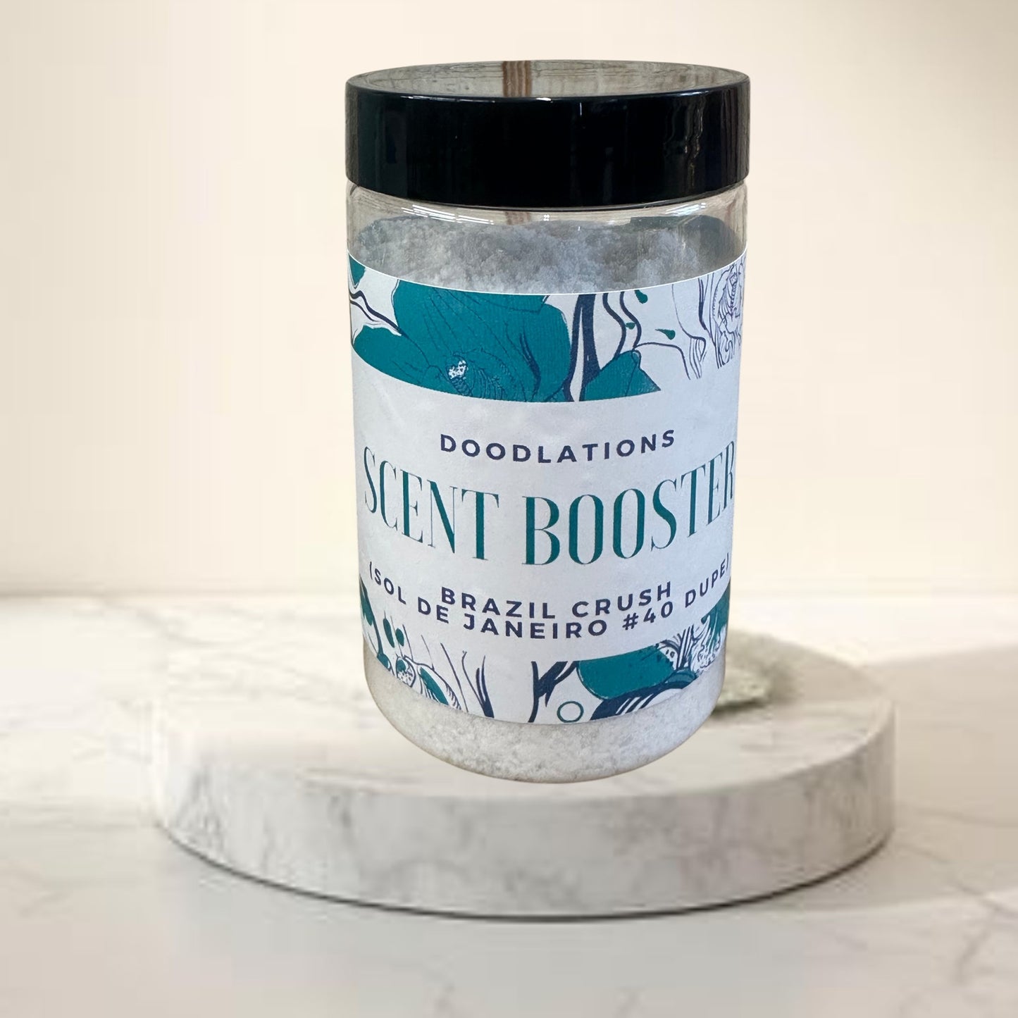 Doodlations Coffee Bar & Boutique Brazilian Crush laundry scent booster in a clear jar with a black lid. Floral design.