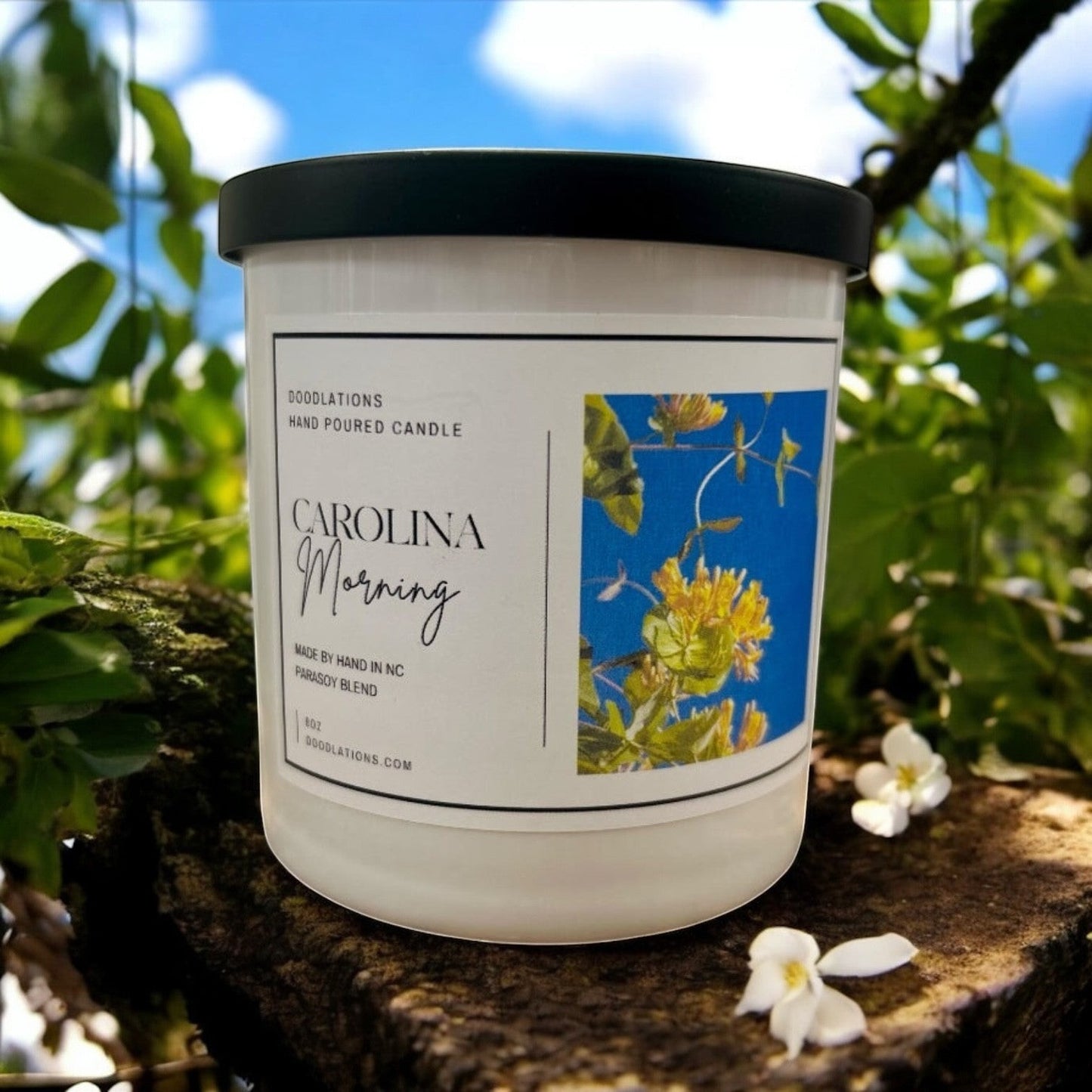 Doodlations Coffee Bar & Boutique hand-poured soy blend candle with floral label.