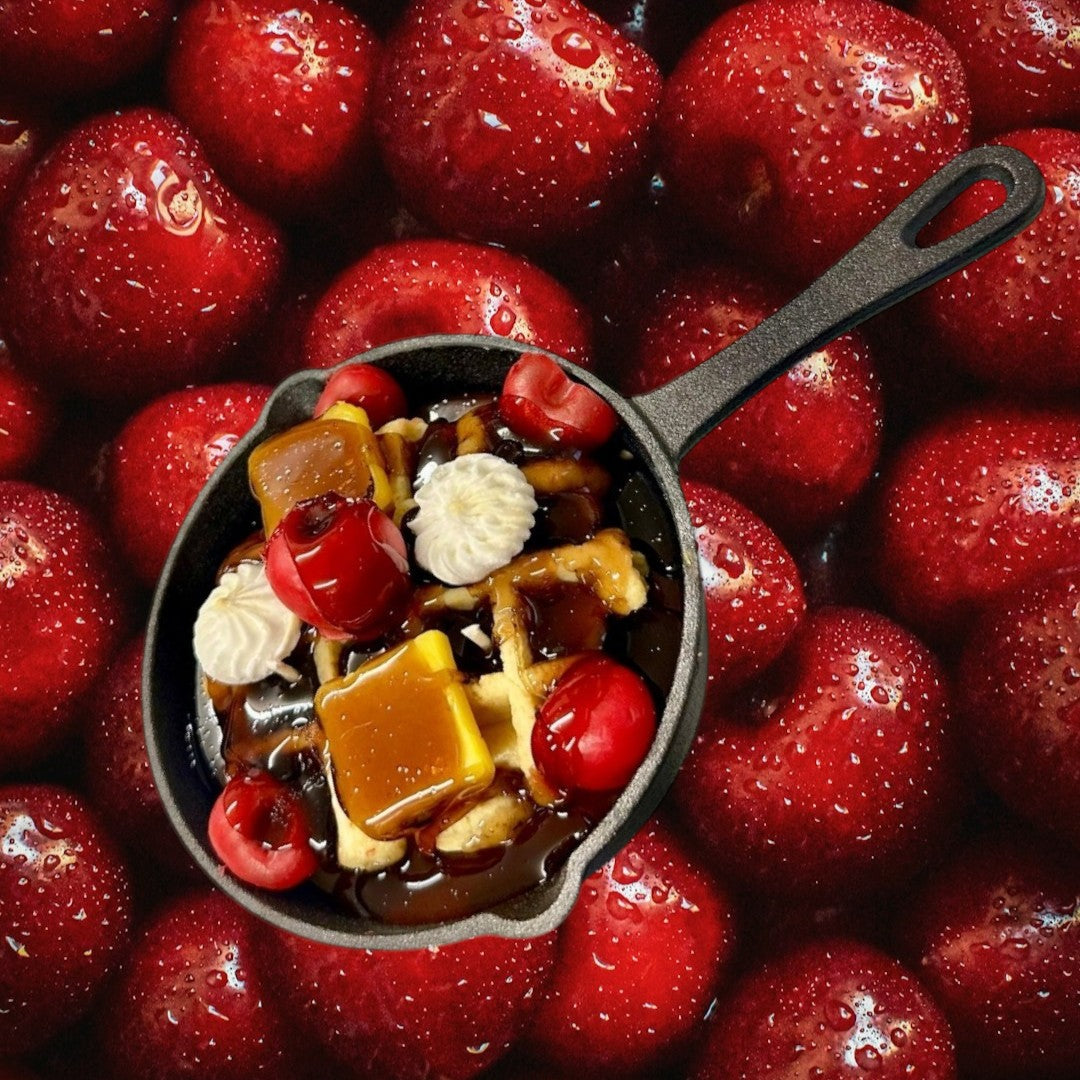 Doodlations Coffee Bar & Boutique Cherry Waffle Skillet Candle with chocolate syrup, cherries, caramel, and whipped cream.