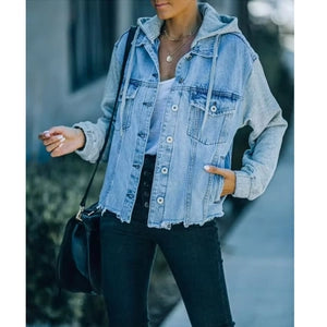 Doodlations Coffee Bar & Boutique oversized light-wash denim jacket with grey jersey sleeves and a drawstring hood.