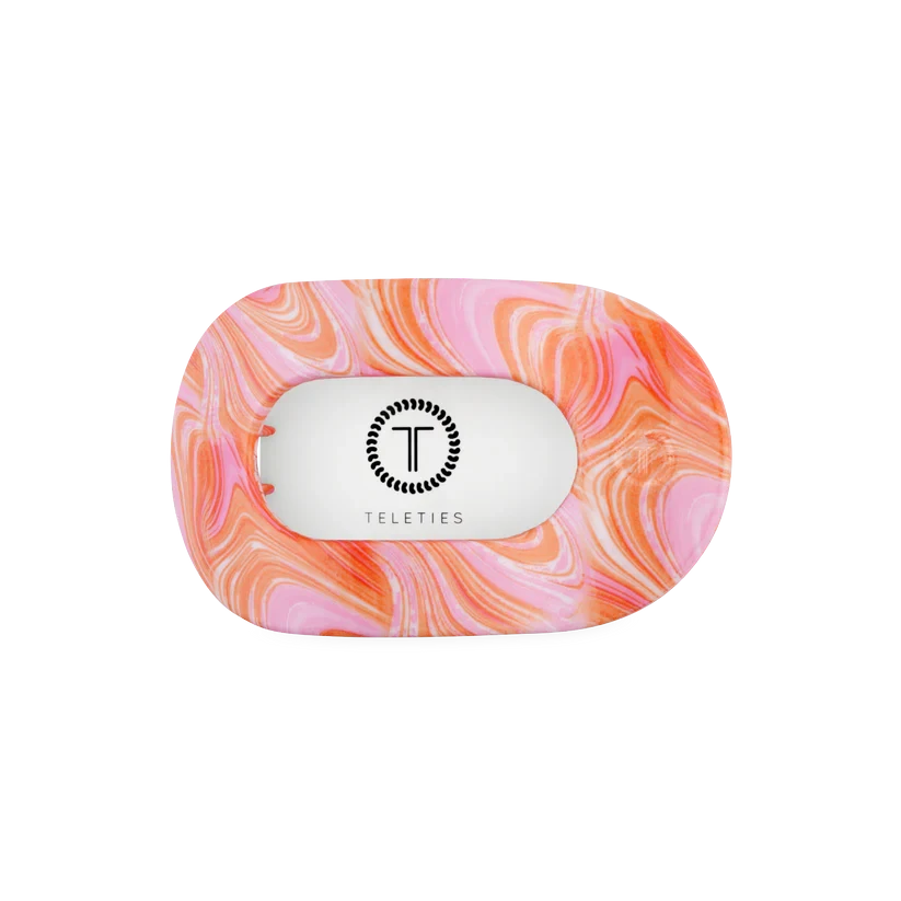 Doodlations Coffee Bar & Boutique Just Keep Swimming flat round hair clip in a pink and orange marbled pattern