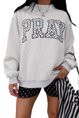 Doodlations Coffee Bar & Boutique gray mock neck sweatshirt with polka dot PRAY embroidery on a model