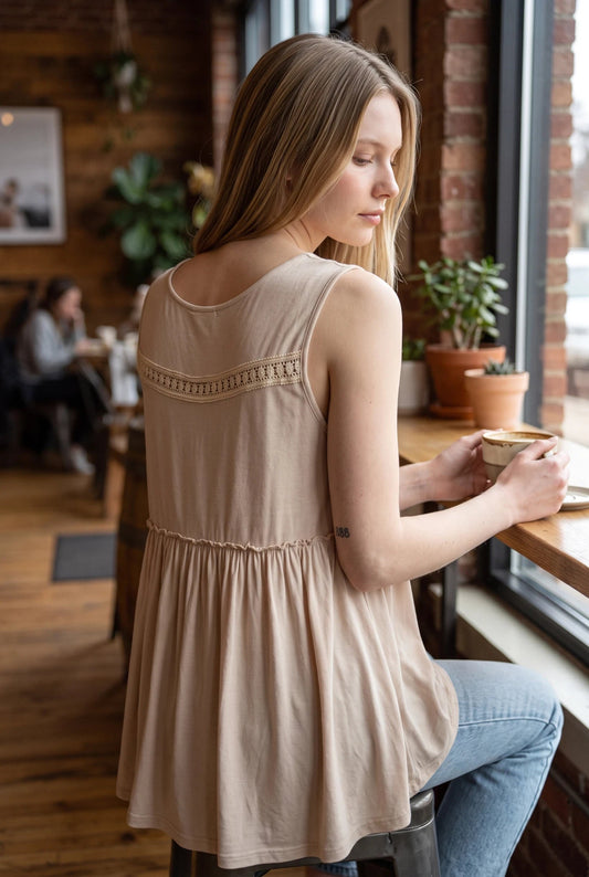Doodlations Coffee Bar & Boutique ivory sleeveless tank top with lace trim and a flowy silhouette worn by a woman