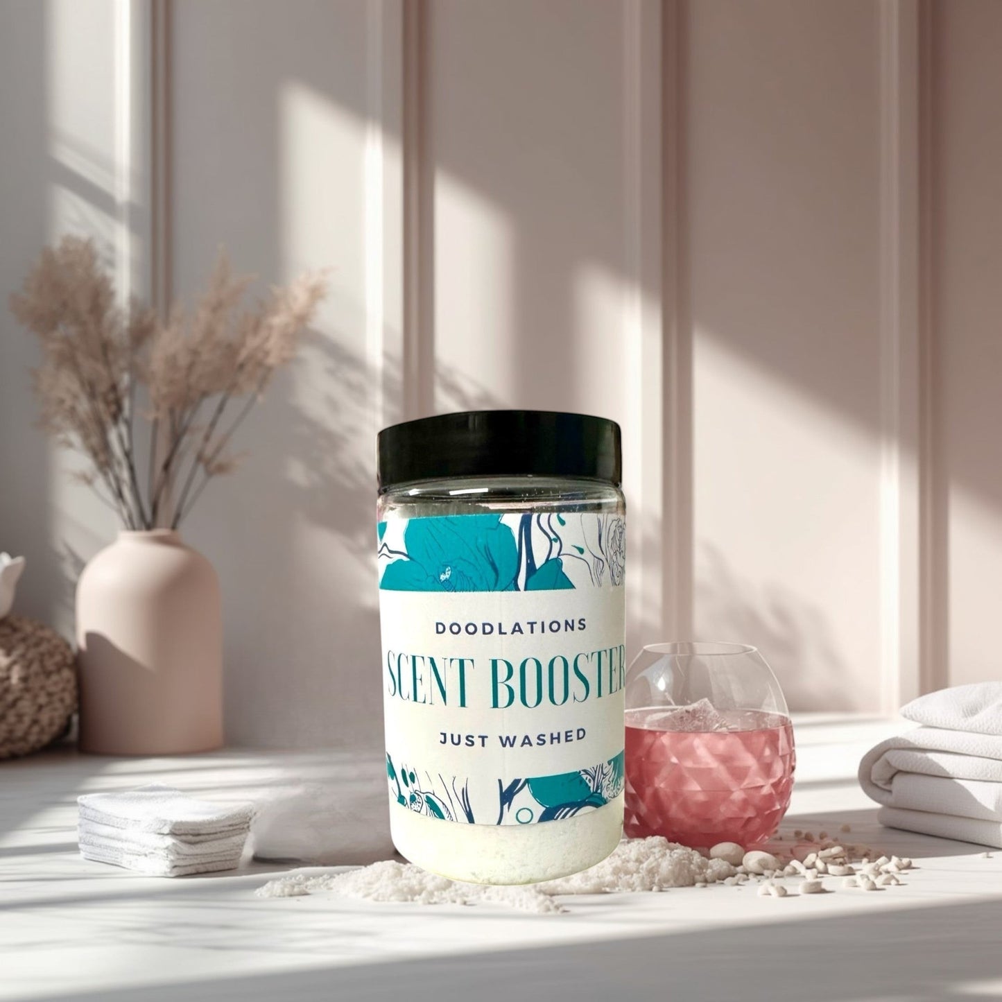 Doodlations Coffee Bar & Boutique Just Washed scent booster in a clear jar with white beads.