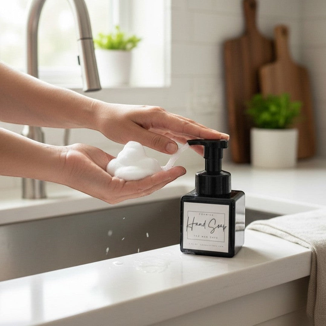 Doodlations Coffee Bar & Boutique Man Cave Foaming Hand Soap dispenser with black pump, dispensing foam into hands.