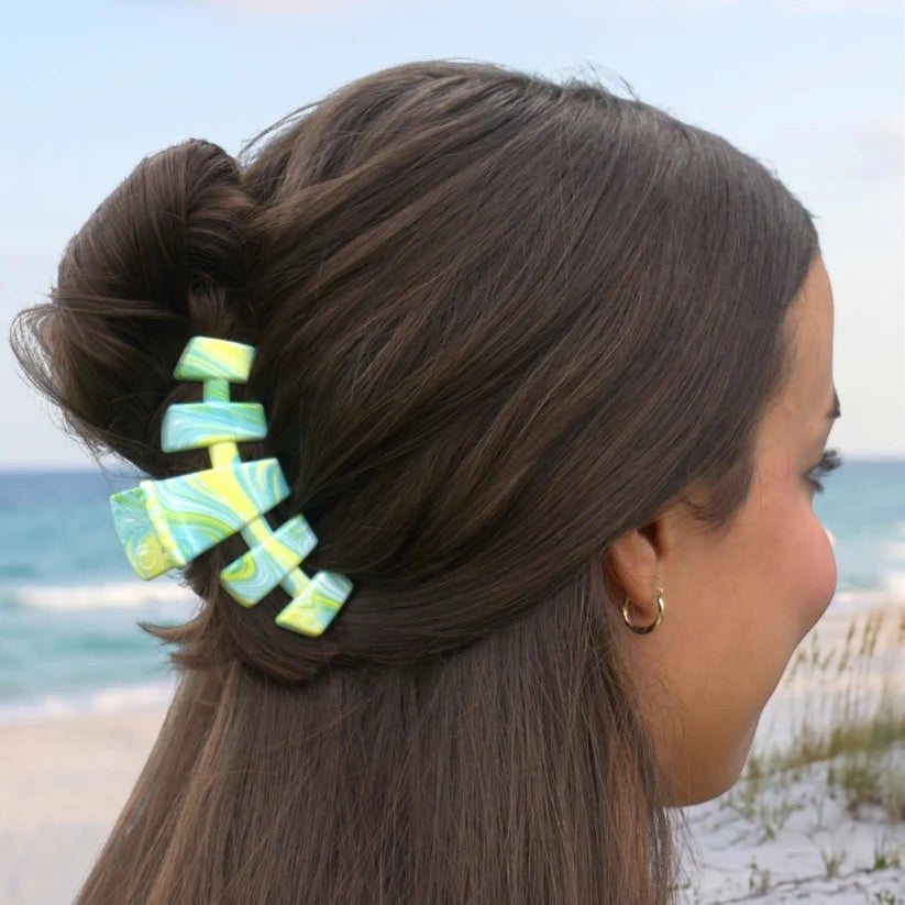 Doodlations Coffee Bar & Boutique Classic By the Sea Shore claw clip in a blue and yellow marbled design in hair