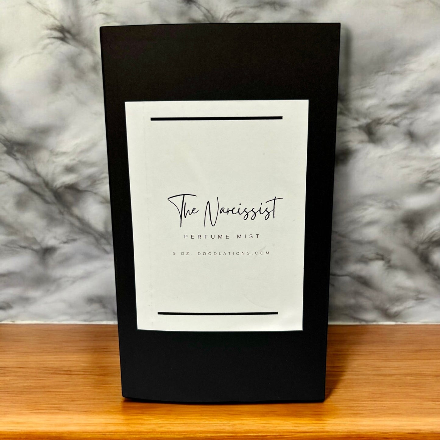Doodlations Coffee Bar & Boutique The Narcissist luxury fine mist perfume in a sleek black 5 oz bottle.