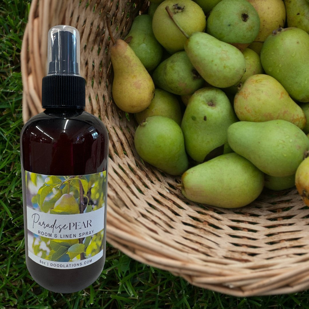 Doodlations Coffee Bar & Boutique Paradise Pear room and linen spray in a dark amber bottle with a spray nozzle.