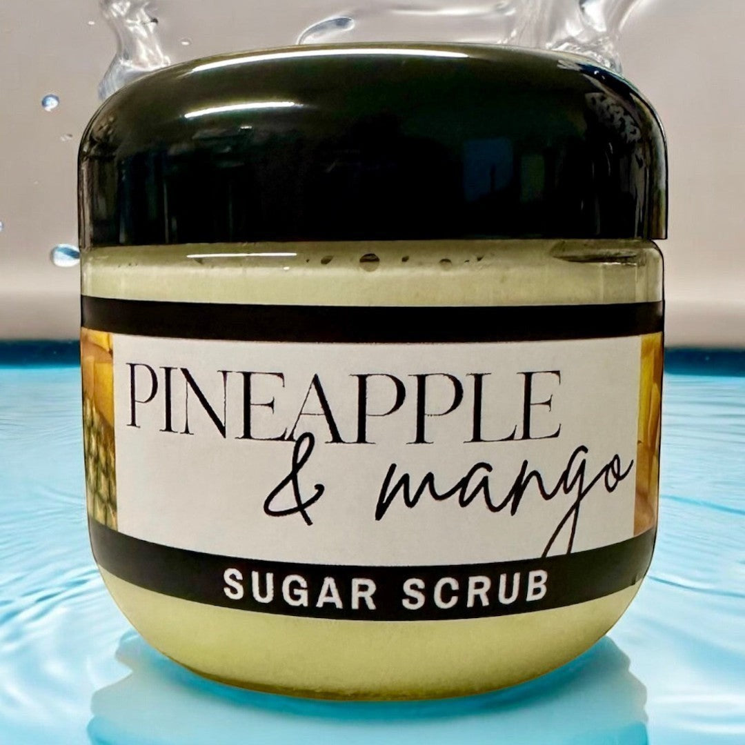 Doodlations Coffee Bar & Boutique Pineapple Mango sugar scrub in a clear jar with a black lid, 4 oz.