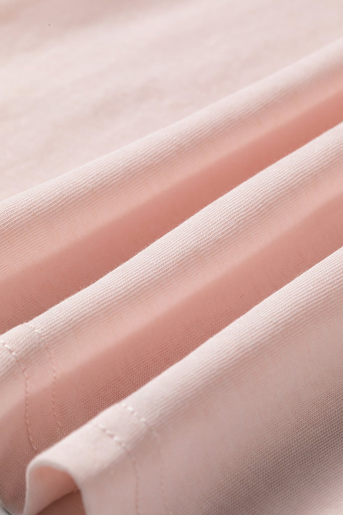 Doodlations Coffee Bar & Boutique baby pink long sleeve top fabric detail showing soft texture and stitching