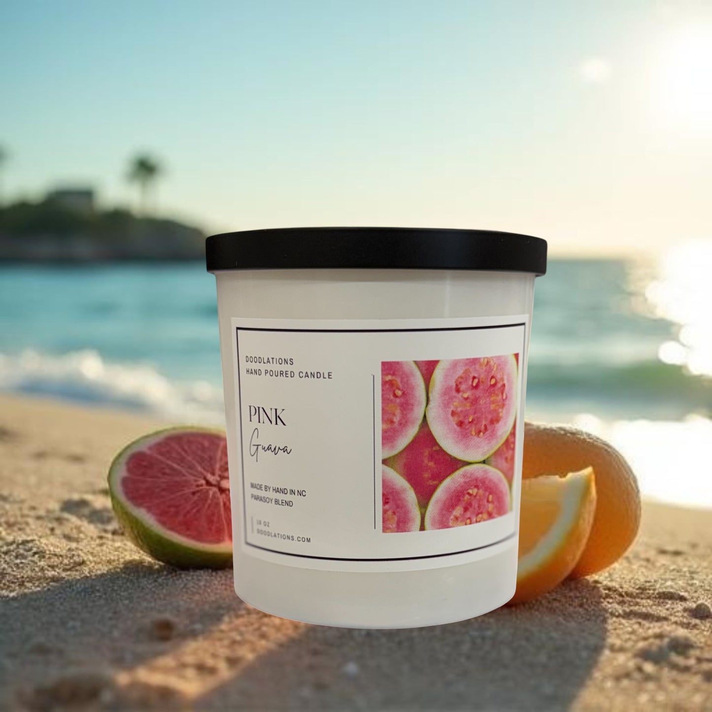 Doodlations Coffee Bar & Boutique Pink Guava hand-poured soy blend candle with a tropical beach background.