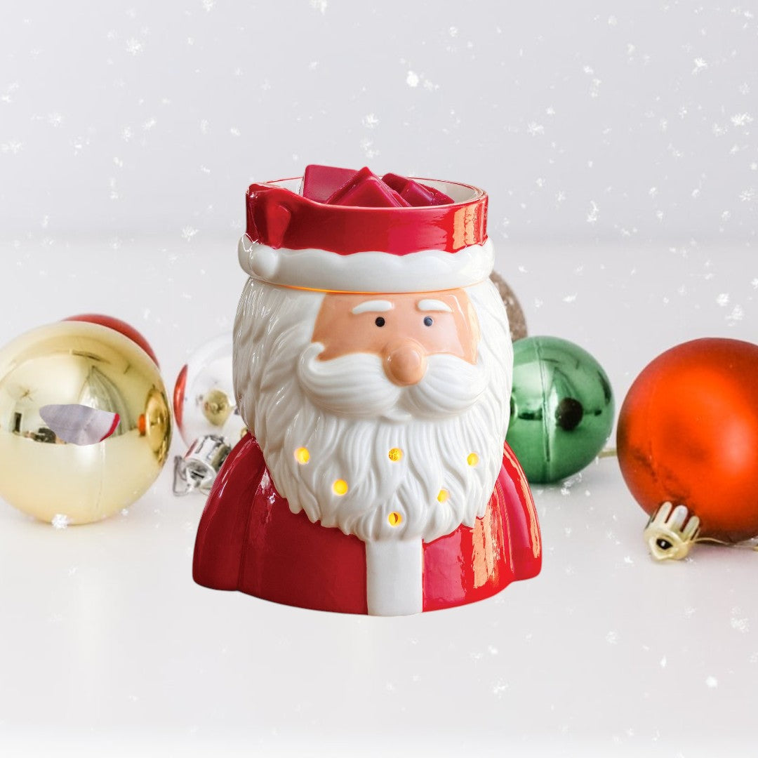 Doodlations St. Nick Fragrance Warmer, a ceramic Santa Claus wax warmer with red suit and white beard, emitting a warm glow.