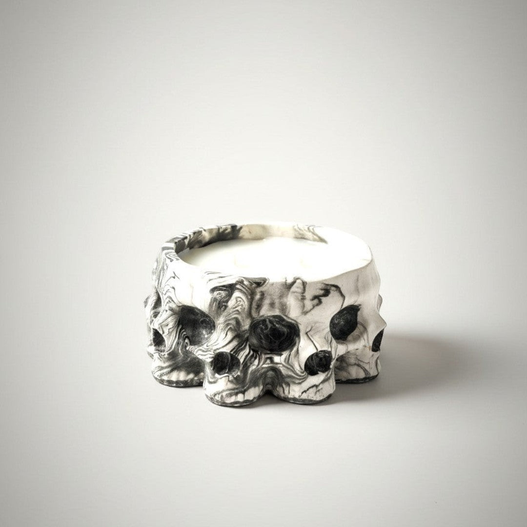 Doodlations Coffee Bar & Boutique Skull Concrete Candle with two wicks and Amish Harvest scent. White soy blend wax in a marbled black and white concrete skull vessel.