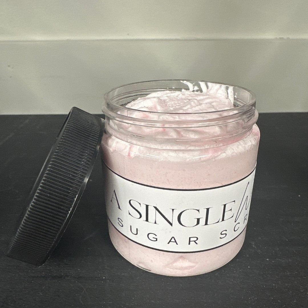 Doodlations Coffee Bar & Boutique A Single Wish pink sugar scrub in a clear jar with a black lid.