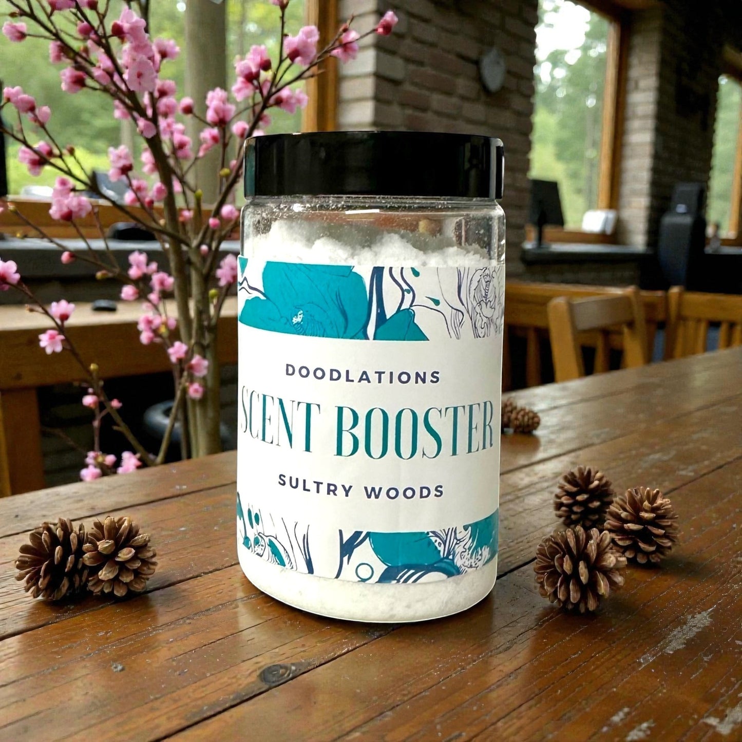 Doodlations Coffee Bar & Boutique Sultry Woods laundry scent booster in a clear plastic jar with a black lid. White granules fill the jar.