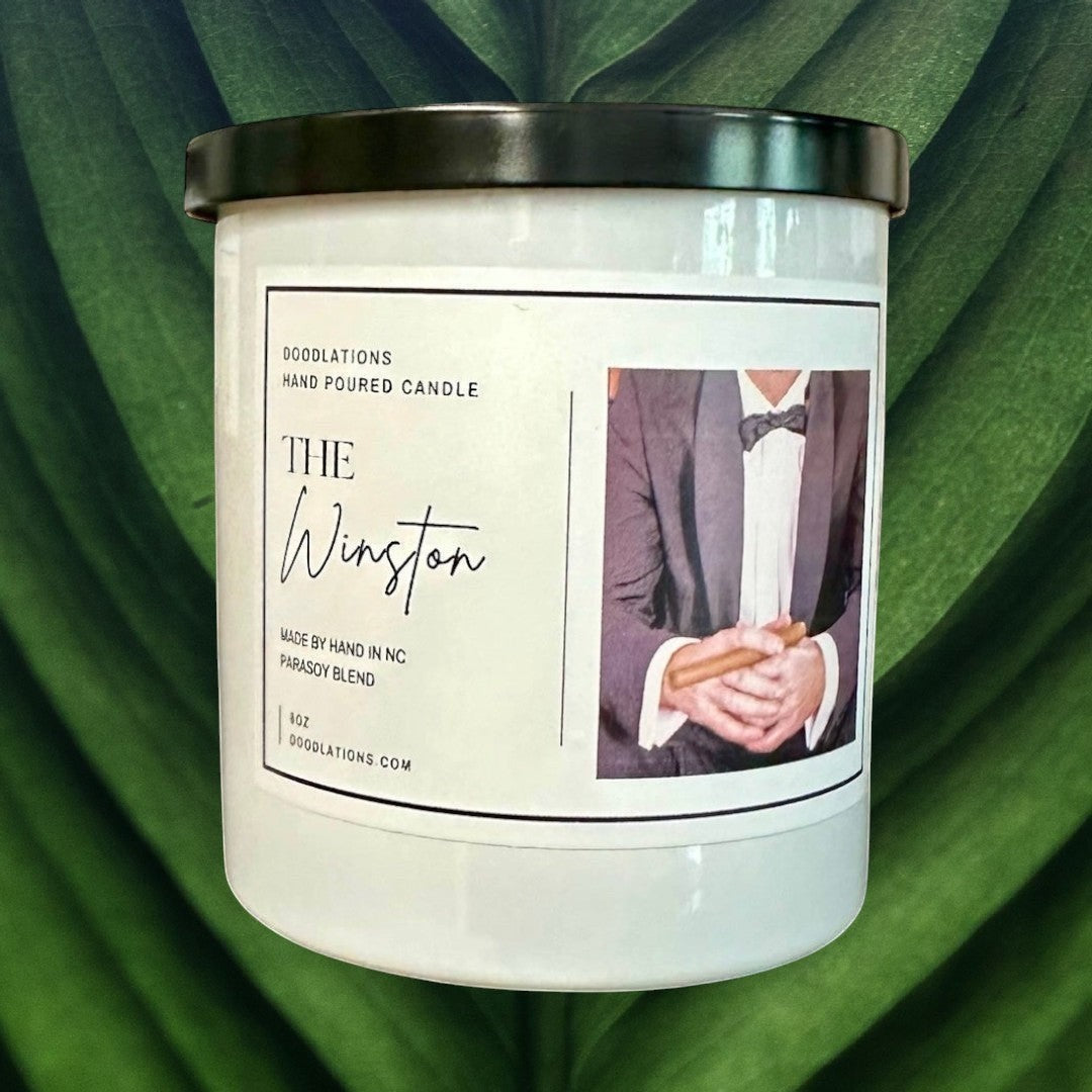 Doodlations Coffee Bar & Boutique The Winston hand-poured soy blend candle with notes of tobacco, honey, amaretto, and oak.