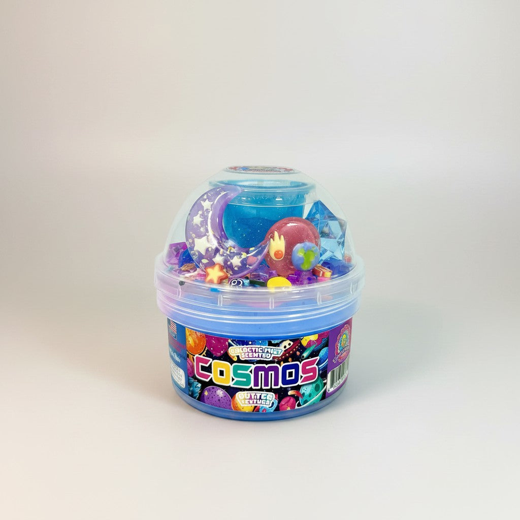 Doodlations Coffee Bar & Boutique Cosmos slime in a blue tub with galaxy-themed charms, glitter, and purple and blue swirls.