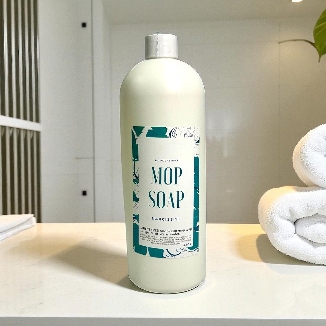 Doodlations Concentrated Mop Soap in The Narcissist scent, a peach and raspberry floral blend, 32 oz bottle.