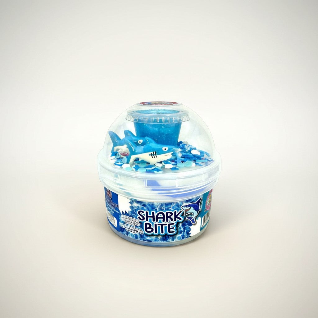 Doodlations Coffee Bar & Boutique Shark Bite slime with blue glitter, shark toy, and ocean-themed charms.