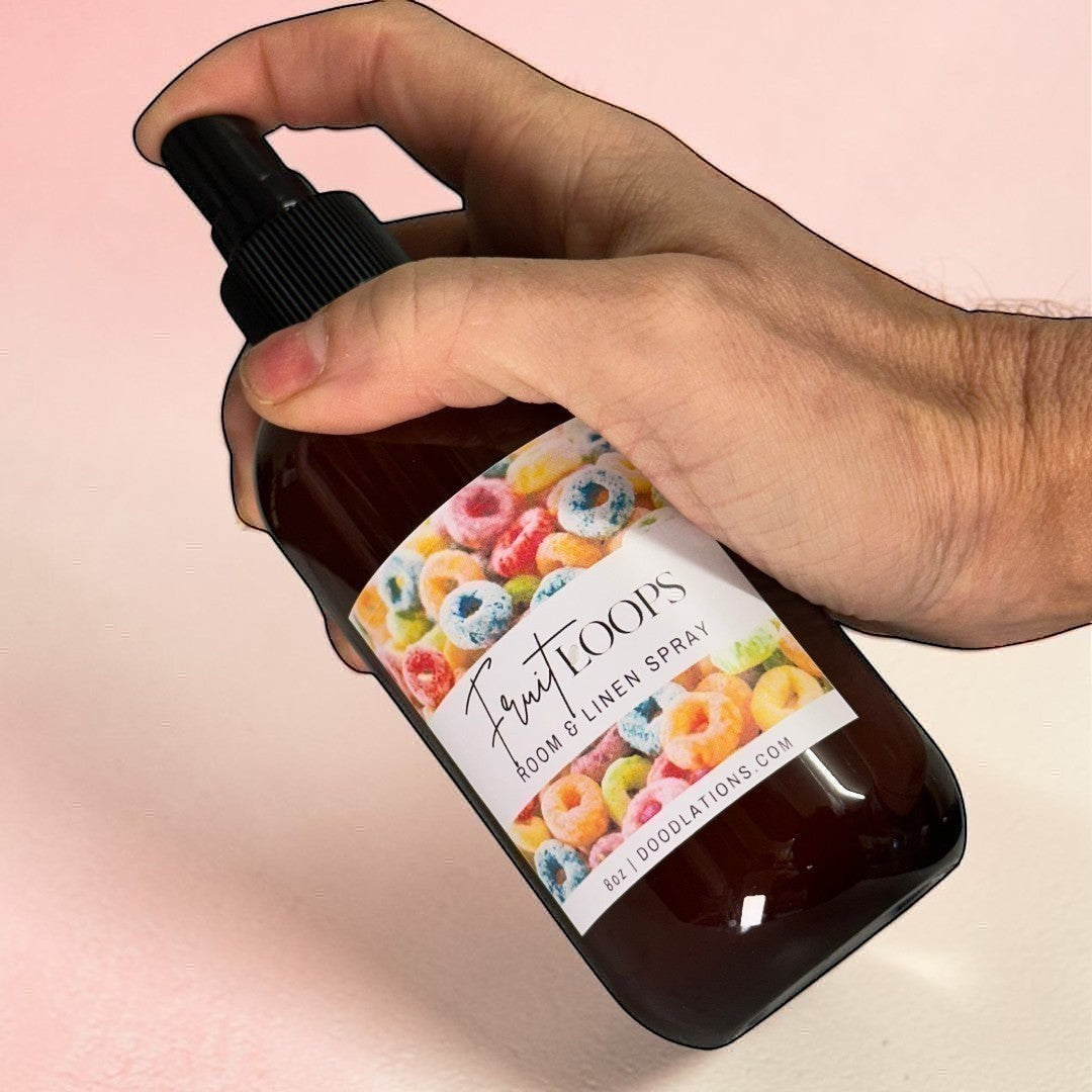 Dodolations Fruit Loops linen spray in amber bottle with colorful cereal label.