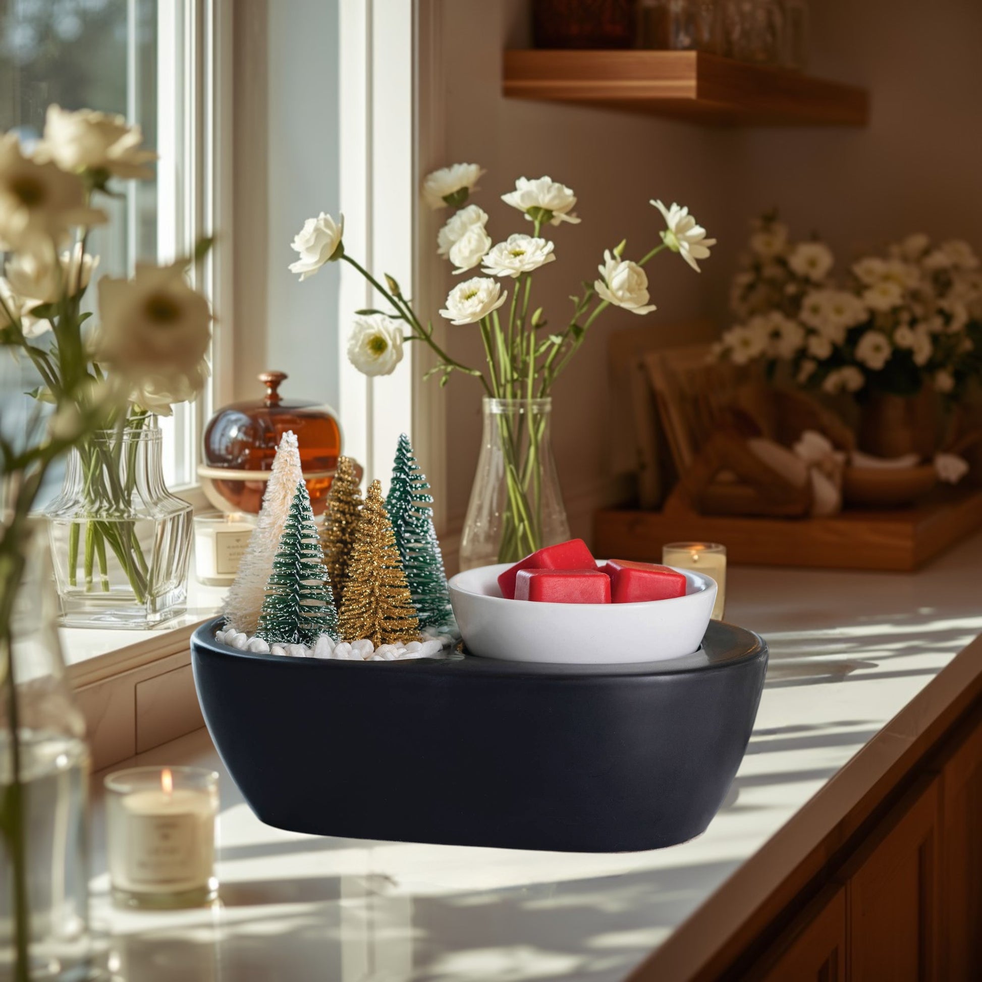 black wax warmer with bottle brush trees and green wax melts.