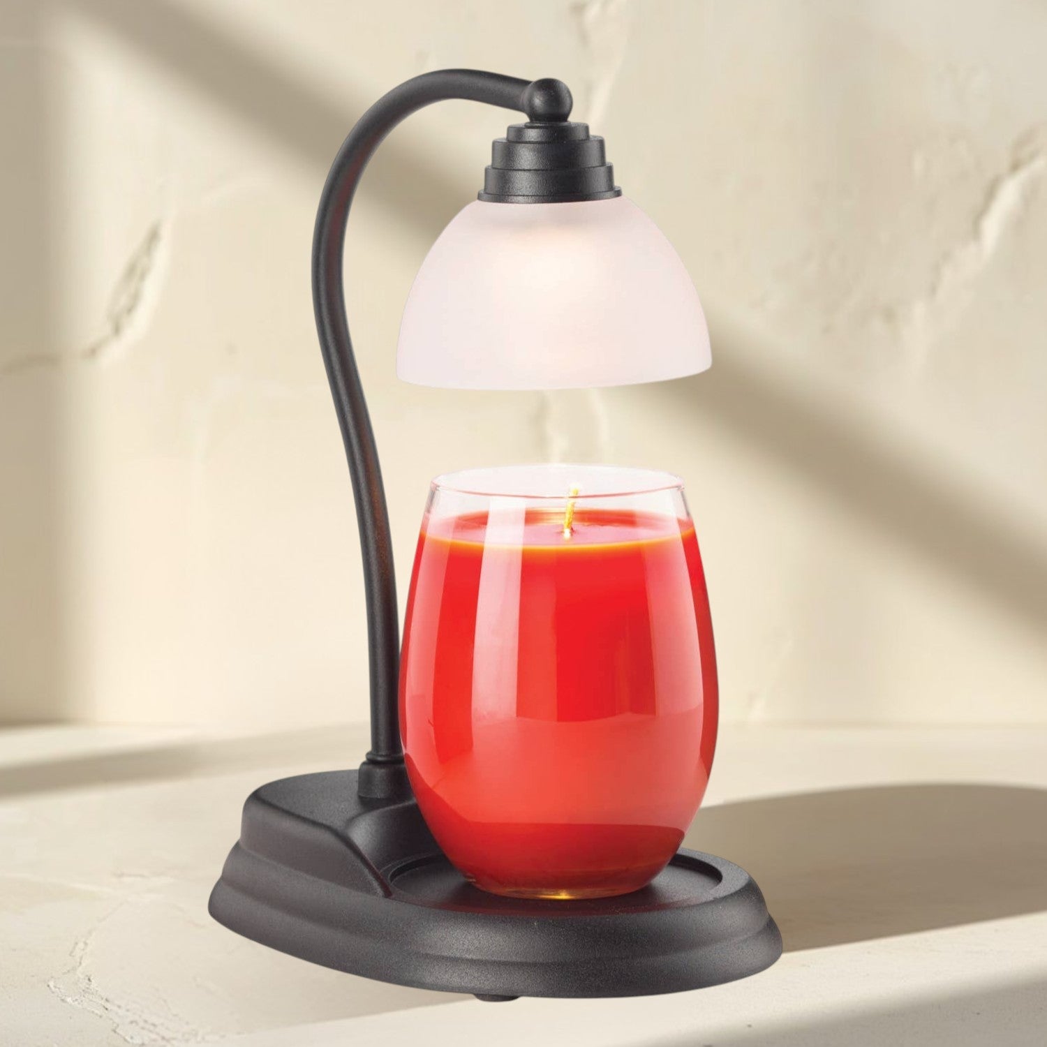Aurora black candle warmer lamp with frosted shade and red candle.