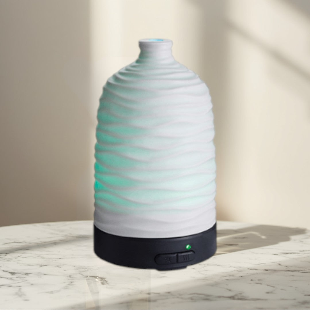 white wavy ceramic essential oil diffuser with green LED light