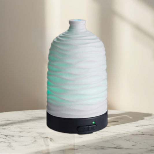 white wavy ceramic essential oil diffuser with green LED light