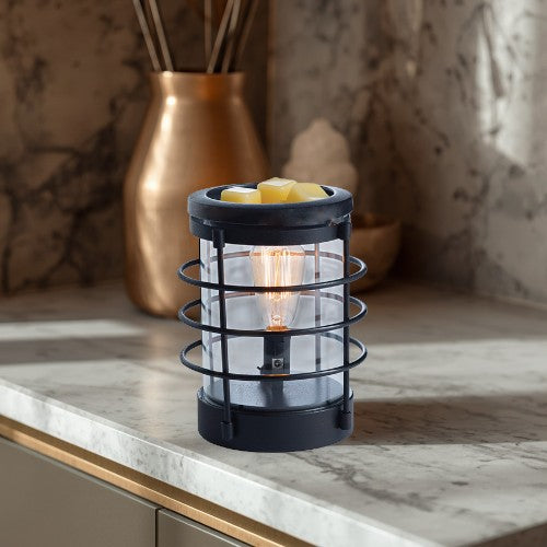 Coastal Vintage Bulb Illumination wax warmer with green wax melts and a warm glowing bulb.
