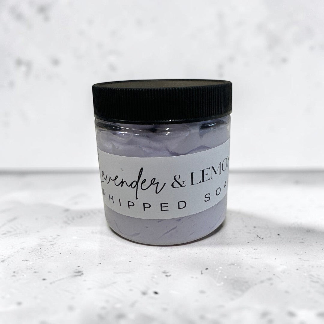 lavender and lemon whipped body soap in a 4oz clear jar with a black lid.