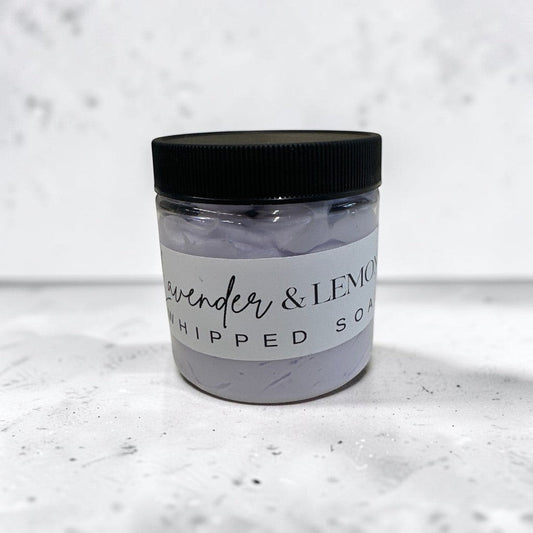 lavender and lemon whipped body soap in a 4oz clear jar with a black lid.