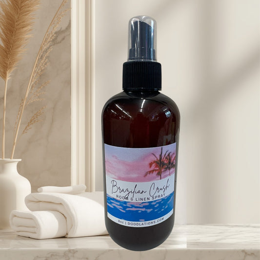 Brazilian Crush room & linen spray in amber bottle with tropical sunset label.